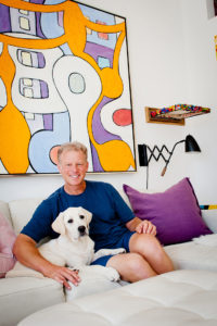 Artist Ed Massey at home with his dog, Milo. Photo: Lesly Hall