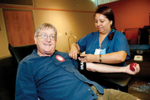 Red Cross nurse Adela Camargo took blood from donor Dan Huntington. Photo: Lesly Hall