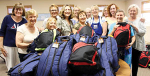 Members of the Assistance League supplied 870 backpacks. Palisadian Mary Ann Lessin is second from the left in the green shirt.