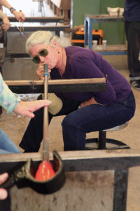 Artist Terry Bromberg blowing glass.
