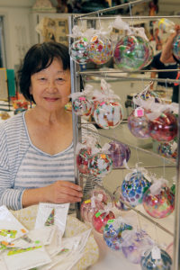 Palisadian Dorothy Miyake sells her Christmas ornaments at the SMC open house.